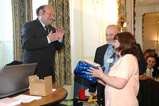 David Sedgwick leads the applause after presenting Jean and June Depin with a wedding gift